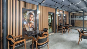 A modern interior with wooden panel walls, a glass table, and leather chairs. - Crestium Taksim Prive&Spa (Istanbul)