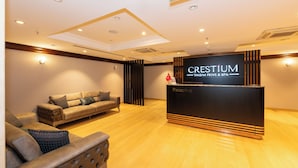 A reception area with a reception desk labeled "CRESTIUM Taksim Privé & Spa," a sofa, and a chair. - Crestium Taksim Prive&Spa (Istanbul)