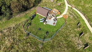 An aerial view of a property with a large house, a fenced yard, and a gravel path. - Rutland Rural Retreats - Bumblebee cabin - Super dog friendly, adult only (Belton In Rutland)