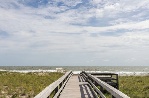 Modern condo with community pool steps from beach!