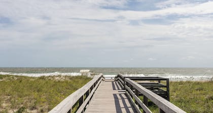 Modern condo with community pool steps from beach!