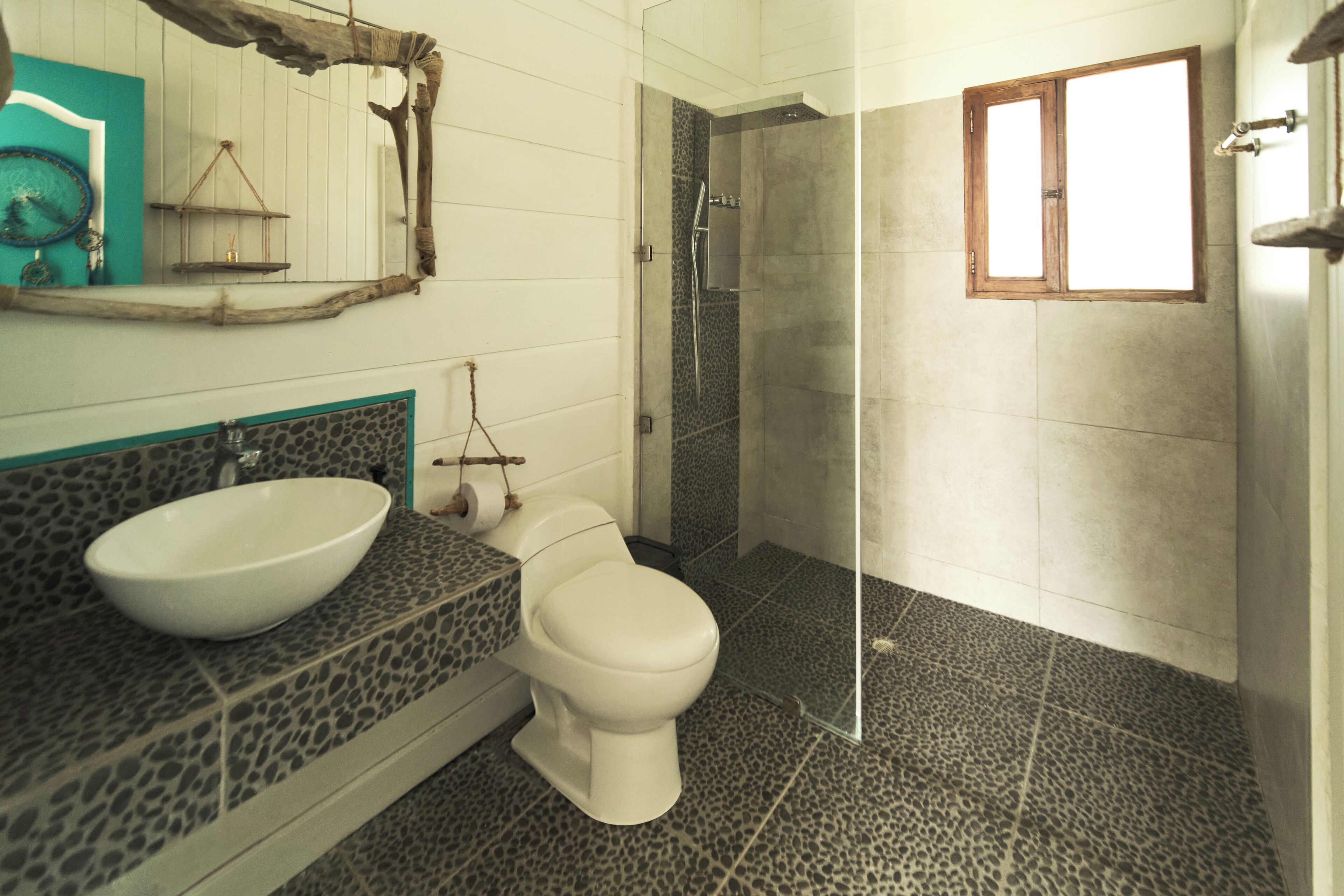 A bathroom with a white sink, a toilet, and a shower area.