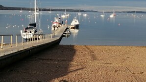 A marina with boats docked along a wooden pier.