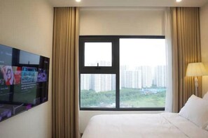 Relax in comfort with a large bed and city views from the large window.