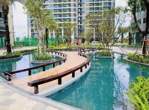 Enjoy a refreshing dip in the pool surrounded by lush greenery and trees.