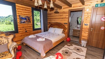 A wooden cabin bedroom with a bed, a chair, a window, and a door.