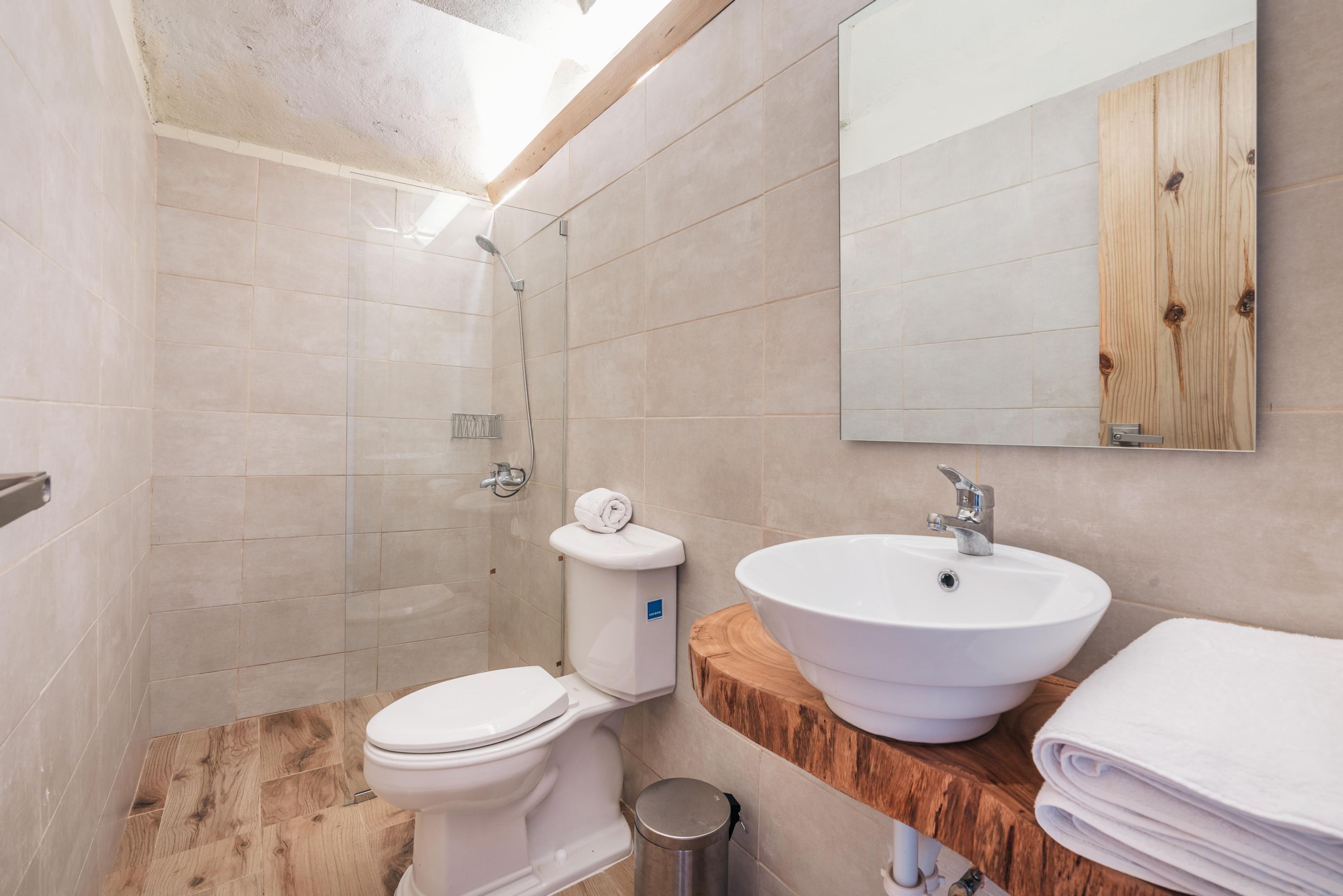 A modern bathroom with a toilet, sink, and shower.