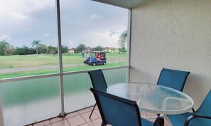 Enjoy dining or relaxing on the balcony with a view of the surrounding golf course and lush greenery.