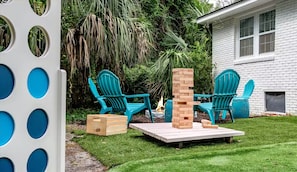 A patio with outdoor furniture and a brick fireplace. - Four Bedroom Beach House - Walk to Park and Beach (Isle of Palms)