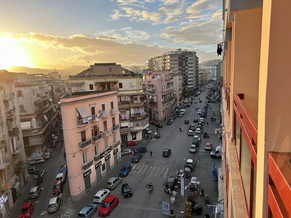 A city street with buildings on both sides, cars, and a few pedestrians. - B&B OFF Rooms and Relax  (Naples)