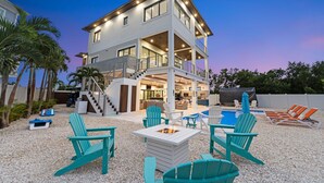 A two-story house with a pool, outdoor seating, and a covered patio area. - Luxury Seaside Escape Pool Dock Scenic Views (Marathon)