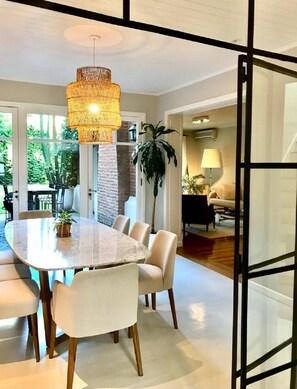 Enjoy meals in this stylish dining area with a large round table and six chairs.