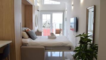 Escritorio, tabla de planchar con plancha, wifi y ropa de cama