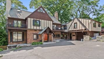 A two-story house with a garage, a covered porch, and a driveway.