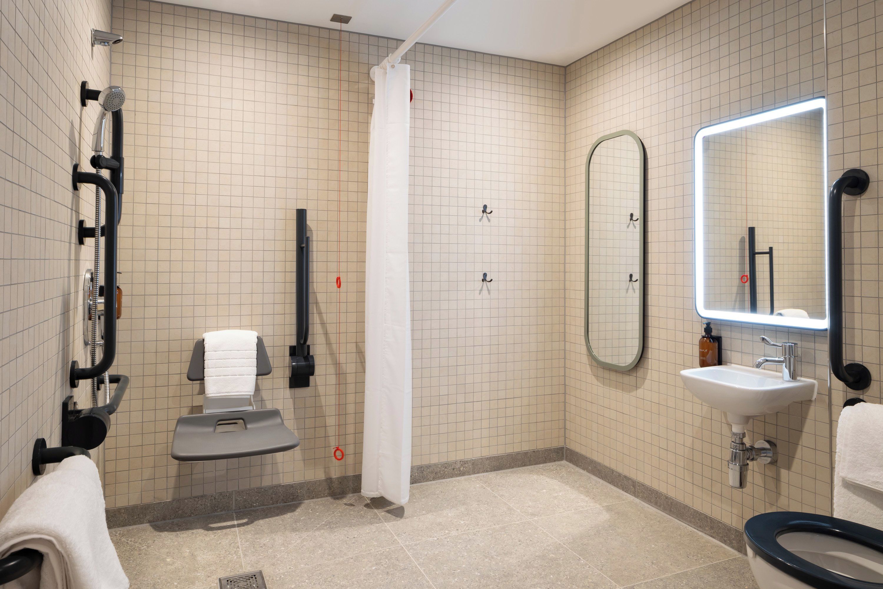 A modern bathroom with a toilet, sink, and shower.