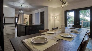 A modern kitchen with a dining area. - 4BR/3BA Cabin w/ Games & Hot Tub, Near Smoky Mtns (Kodak)
