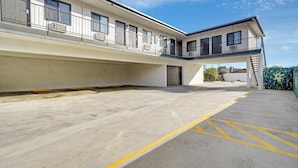 A multi-story building with a flat roof, large windows, and a covered walkway. - Casablanca Inn (Bell Gardens)