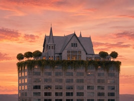 A multi-story building with a unique rooftop garden and a classic architectural style.