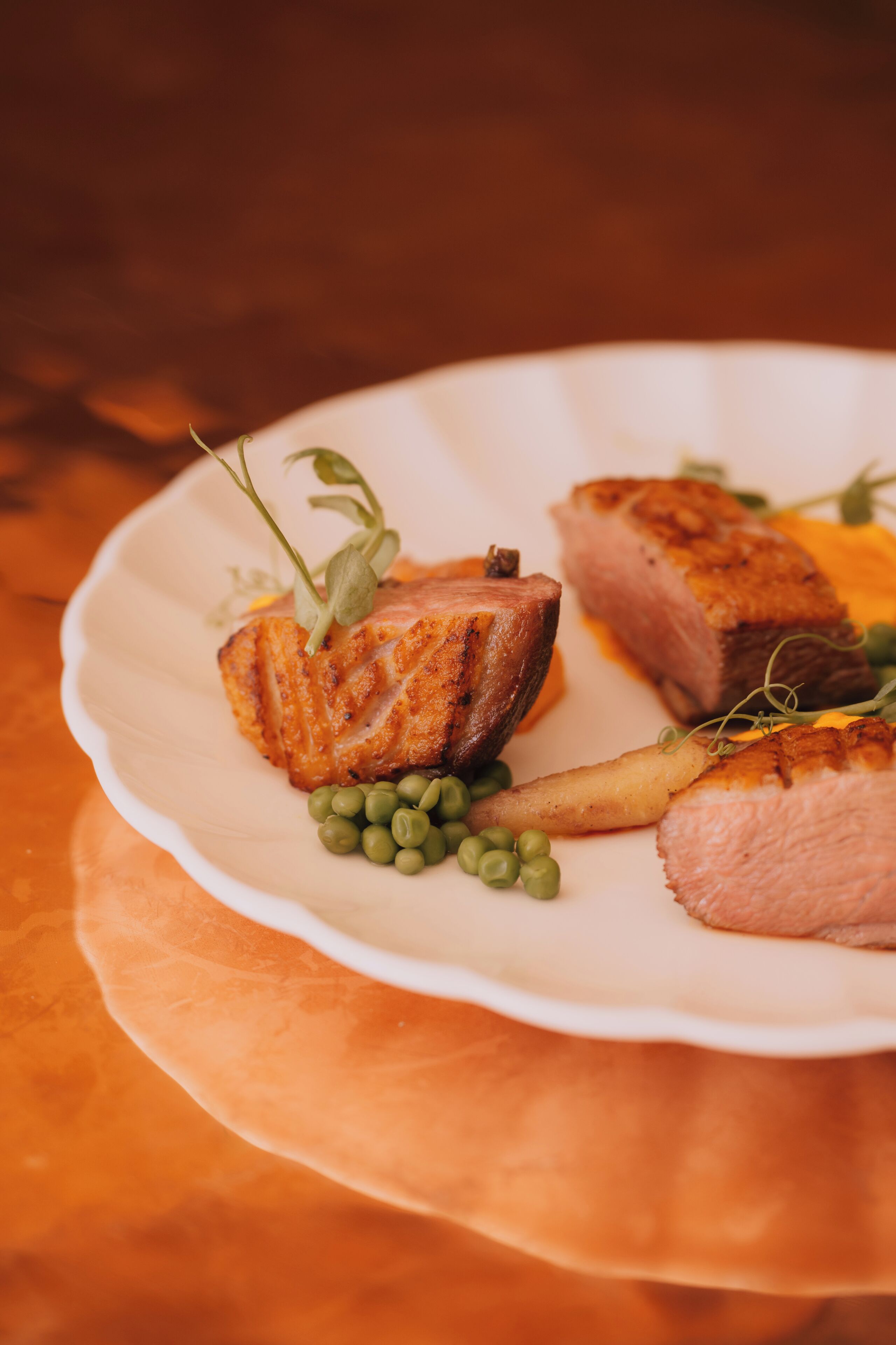A plate of food with salmon and peas.
