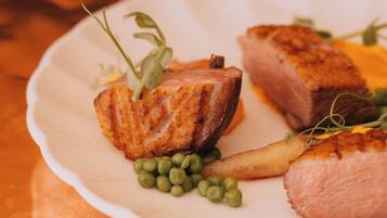 A plate of food with salmon and peas.