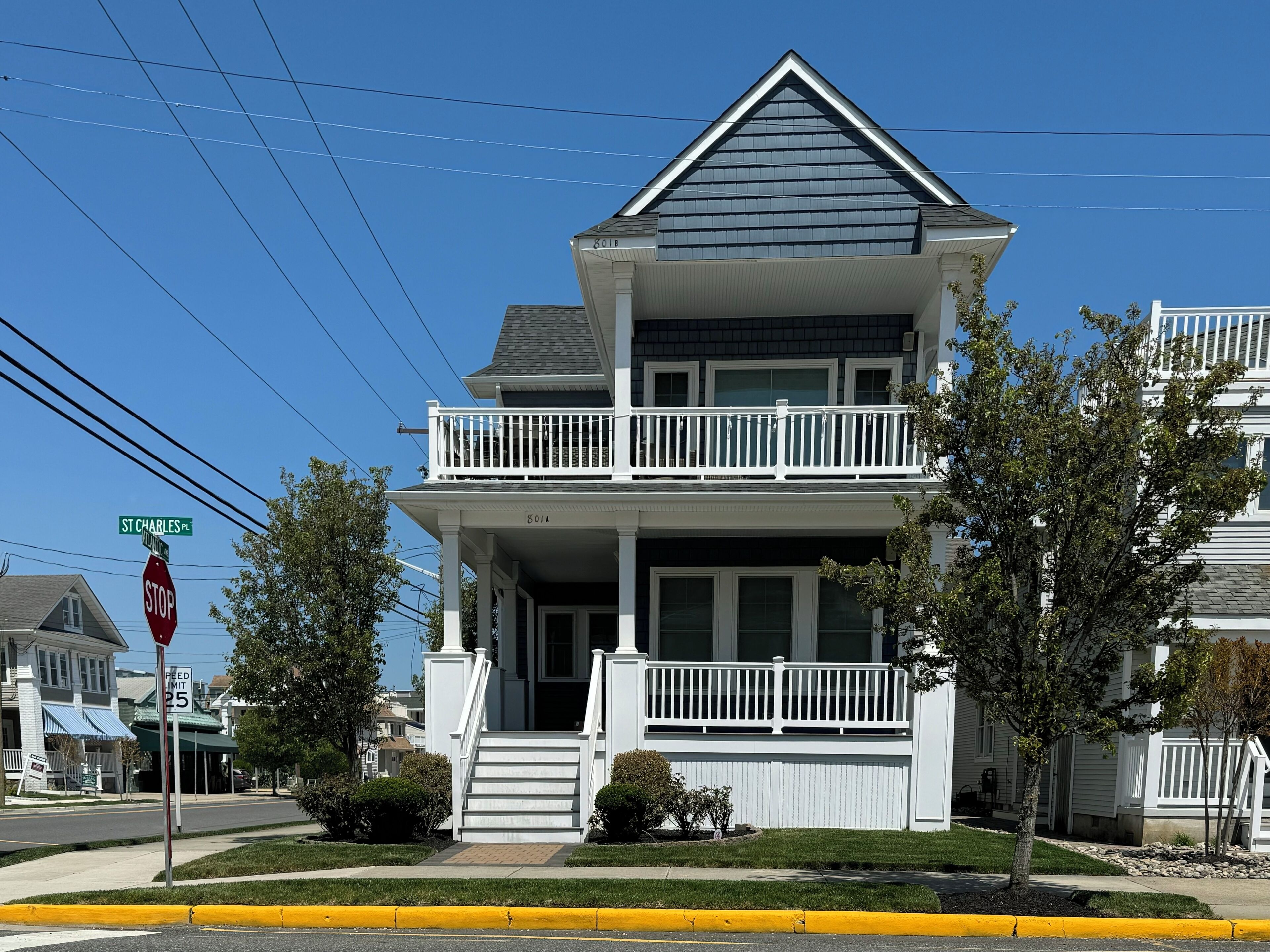 A two-story house with a balcony, a front porch, and a driveway.