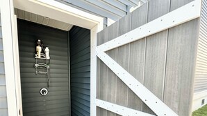 A wooden door with a metal handle and a white metal frame.