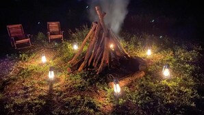 A campfire with lanterns around it, surrounded by chairs. - Hidden Jungle Village Wilpattu (Anuradhapura)
