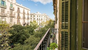 A view of a cityscape with multi-story buildings, balconies, and lush greenery. - Lovely 6 BR Flat in L Eixample (Barcelona)