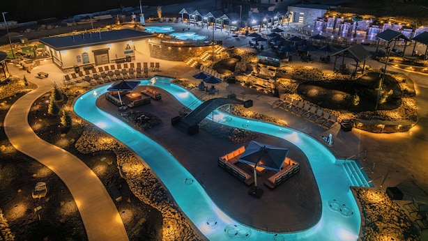 A resort with a large swimming pool, lounge areas, and a building with multiple levels. - Minutes to Parkway! 3600 Sq Ft Cabin w/ Waterpark & Mountain View’s (Sevierville)