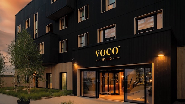 A modern building with a dark facade and large windows, labeled "VOCO BY IHG". - voco Zeal Exeter Science Park by IHG (Exeter)