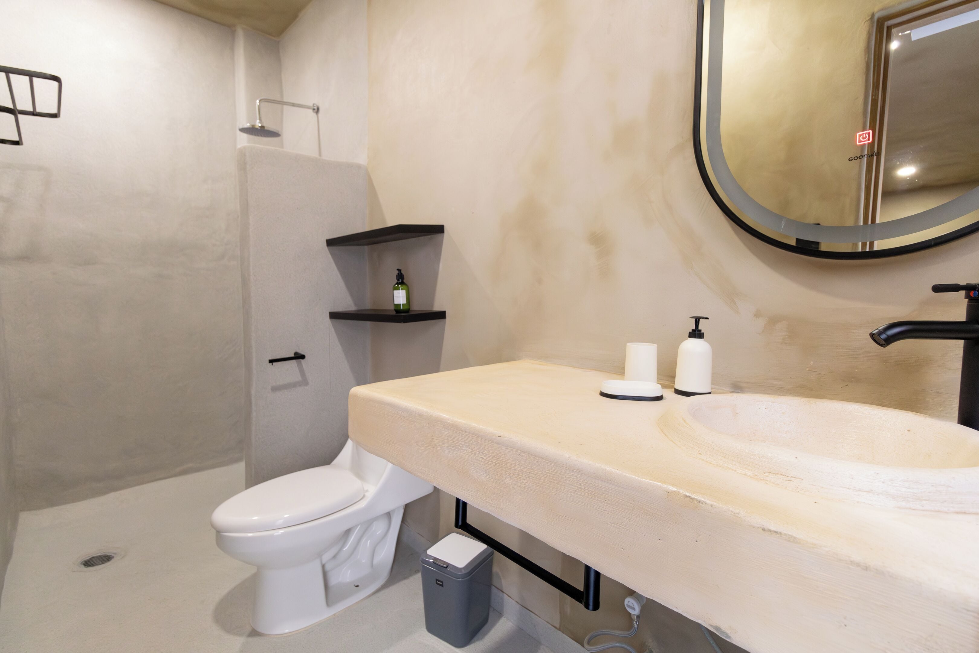 A bathroom with a toilet, sink, and shower.