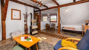 A cozy room with a wooden ceiling, a dining area, a bed, and a view of the outdoors. - Awesome apartment in Ravna Gora with WiFi (Ravna Gora)