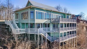 A multi-story house with a balcony and a staircase leading to a deck. - The Lodge in Mentone.  (Mentone)
