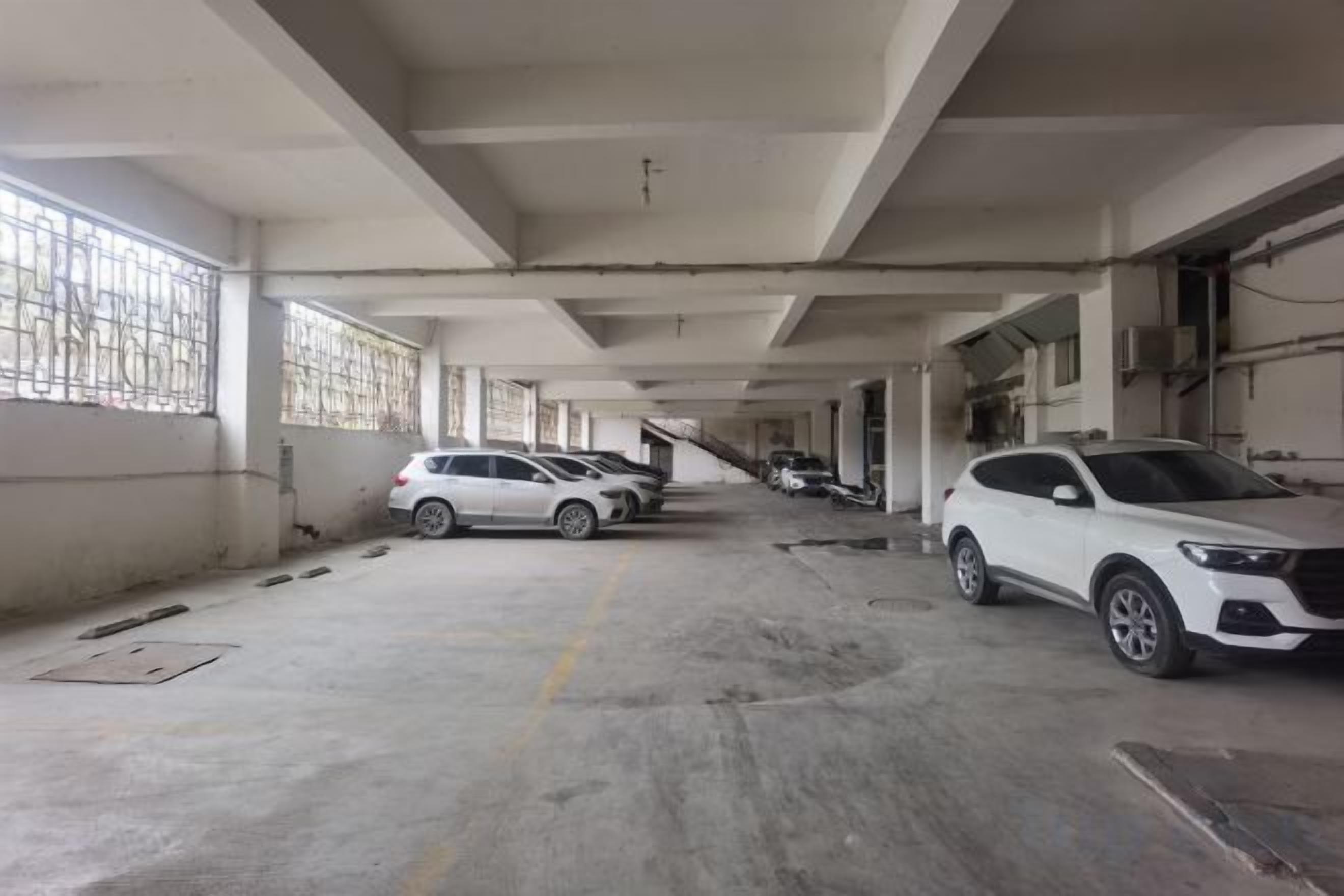 A multi-level parking garage with several cars parked.