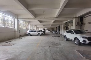 A multi-level parking garage with several cars parked. - Fuhua Hotel (Pingwu)