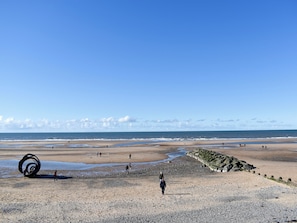A beach with a large spiral sculpture, rocky shoreline, and a clear sky. - 3 bedroom accommodation in Thornton-Cleveleys, near Blackpool (Thornton-Cleveleys, near Blackpool)