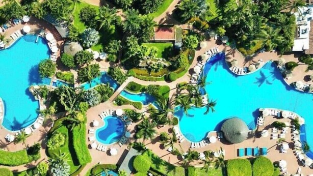 A resort with multiple swimming pools, palm trees, and sun loungers. - Regal 3bd PH with private pool in Beach Resort Spa (Marina Vallarta, Puerto Vallarta)