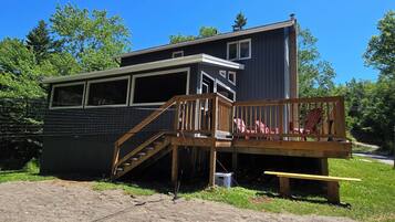 Enjoy a two-story retreat with a spacious deck and seating area, perfect for relaxation and recreation.