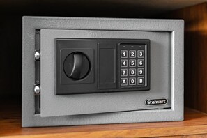 A gray safe with a numeric keypad and a keyhole, labeled 'Stalwart'.