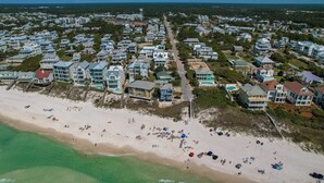 An aerial view of a coastal residential area with beachfront properties, a sandy beach, and a clear view of the ocean. - Sandy Bottoms | Inlet Beach Home 5 Minute Walk to Beach & Private Community Pool (Inlet Beach)