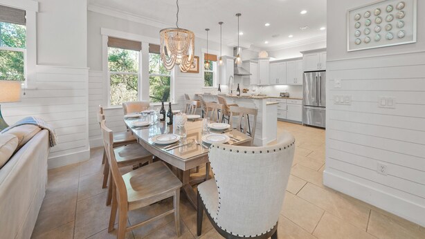 A modern kitchen with white cabinetry, a central island, and pendant lighting. - Sandy Bottoms | Inlet Beach Home 5 Minute Walk to Beach & Private Community Pool (Inlet Beach)