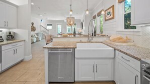 A modern kitchen with granite countertops, stainless steel appliances, and a central island. - Sandy Bottoms | Inlet Beach Home 5 Minute Walk to Beach & Private Community Pool (Inlet Beach)