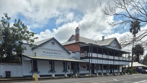 A two-story building with a sign reading "NANUP HOTEL." It features a balcony with a sign for "Food Available." -  Nannup Riverview Cottage, fully Self Contained Holiday Let (Nannup)