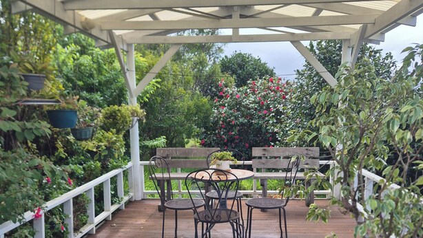 A covered patio with a wooden deck, metal chairs, and tables. -  Nannup Riverview Cottage, fully Self Contained Holiday Let (Nannup)