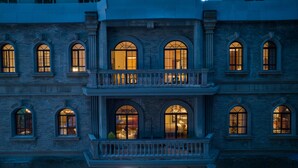A multi-story building with arched windows and a balcony with balustrades. - Golden Age Hotel (Chengdu)