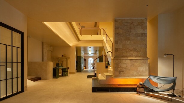 A spacious lobby with a high ceiling, a staircase, and a large column. - Golden Age Hotel (Chengdu)