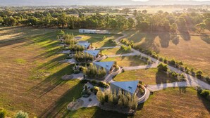 An aerial view of a property with multiple buildings, pathways, and green areas. - Oak Studio as Featured in Grand Designs Magazine (Buckaroo)