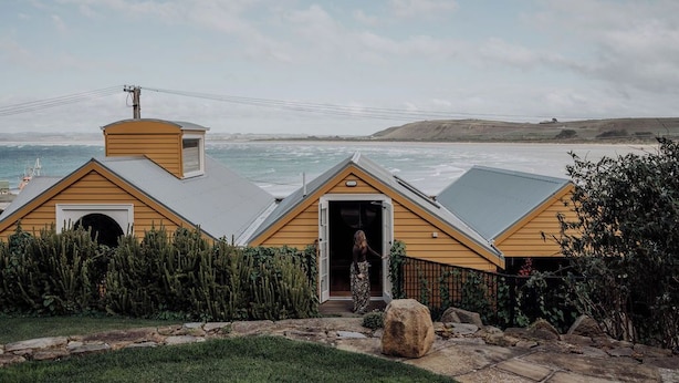 A coastal house with a wooden exterior, a chimney, and a view of the sea. - Ship Inn Stanley (Stanley)