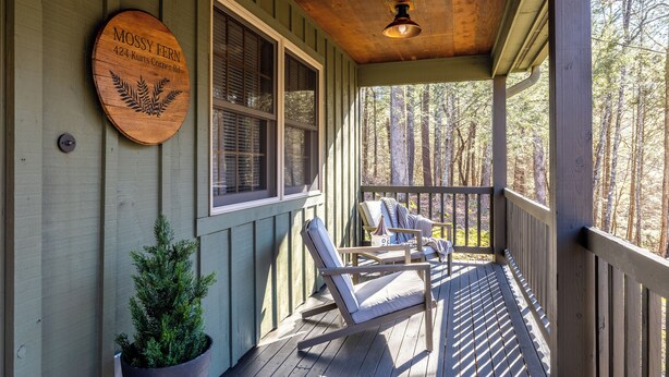 A wooden porch with a sign reading "Mossy Fern 424 Korts Corner Rd." and a potted plant. - Check out Mossy Fern!! A Cozy Cabin in the Woods in Townsend, TN. (Townsend)