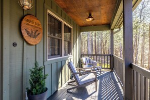 A wooden porch with a sign reading "Mossy Fern 424 Korts Corner Rd." and a potted plant. - Check out Mossy Fern!! A Cozy Cabin in the Woods in Townsend, TN. (Townsend)
